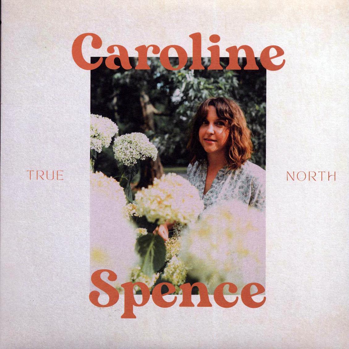 Album cover with a person holding flowers and text 'Caroline Spence True North'.